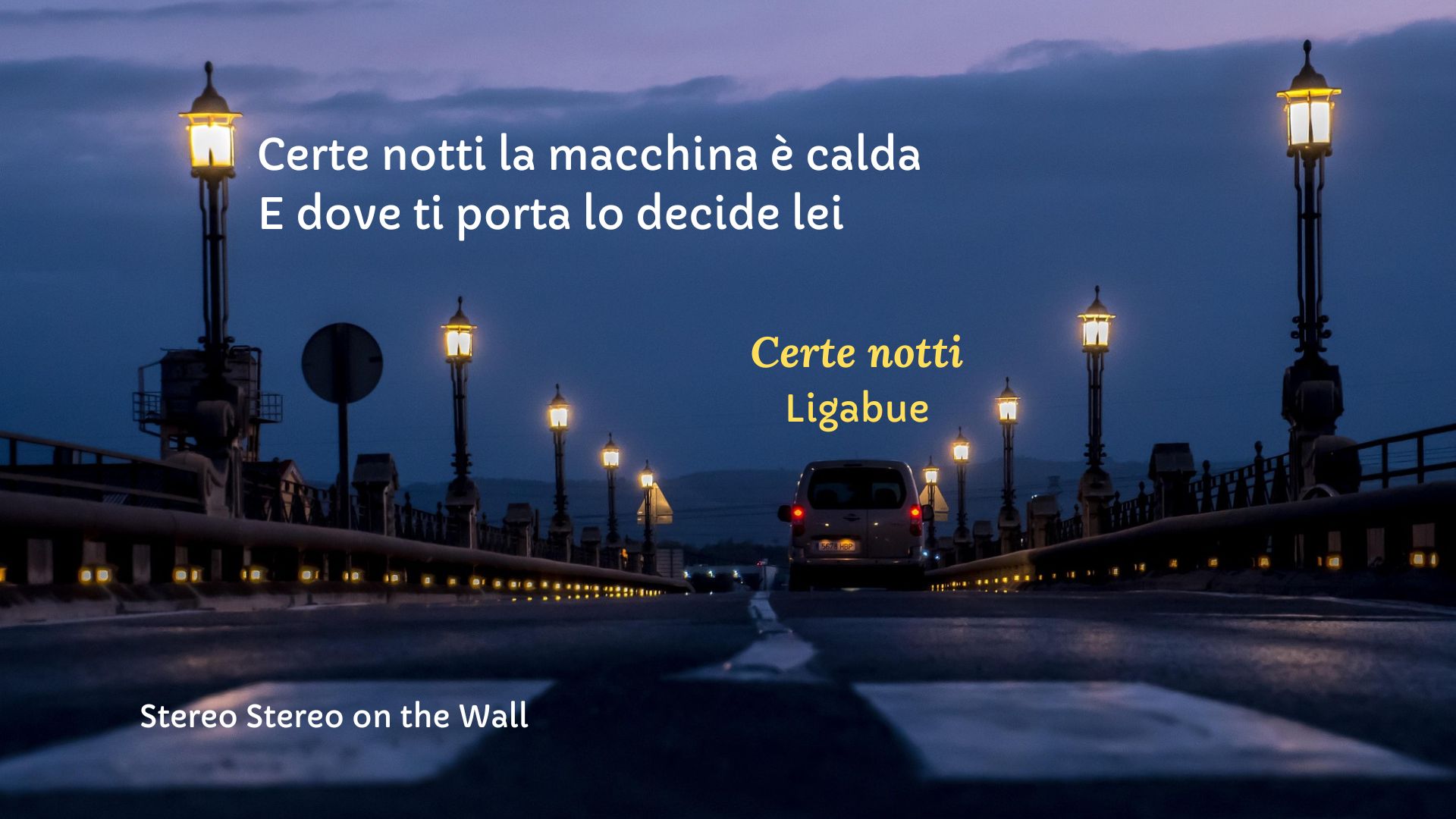 Image of a road at night with a moving car. Above it is the caption “Certe notti la macchina è calda e dove ti porta lo decide lei”, taken from the song “Certe notti” by Ligabue.